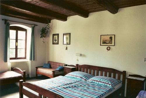 A bed or beds in a room at Pension Červená