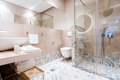 een badkamer met een douche, een wastafel en een toilet bij Villa Mirakul in Sukošan