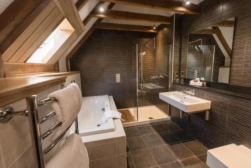a bathroom with a sink, toilet and bathtub at Meldrum House Hotel Golf And Country Estate in Oldmeldrum