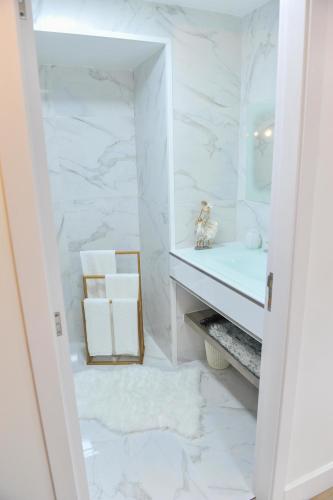 a white bathroom with a sink and a mirror at Casa do Azevinho - Grupo Casas Vale do Lima in Ponte de Lima