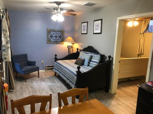 a bedroom with a bed and a table and a chair at Ramsey Canyon B&B Apartment Suites in Nicksville