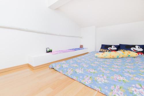 a bedroom with a bed with hello kitty pillows at Haneda Airport Apartment in Tokyo