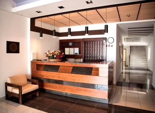 a lobby with a reception desk and a chair at Violetta in Kamena Vourla