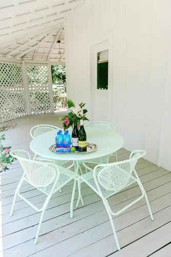 a white table and chairs on a patio at The Frenchie in Round Top
