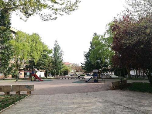 a park with a playground with benches and a playground at Pension Santiago in Burgos