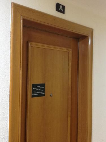 a sign above a door with a sign on it at Pension Santiago in Burgos