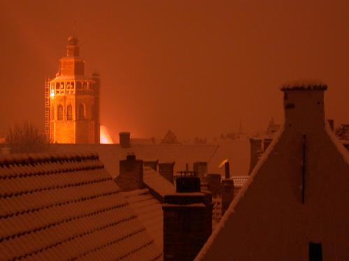 a building with a clock tower at night at B&B 't Walleke in Bruges