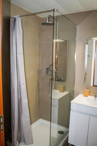 a shower with a glass door in a bathroom at The Best Atlantic Ocean View in Câmara de Lobos