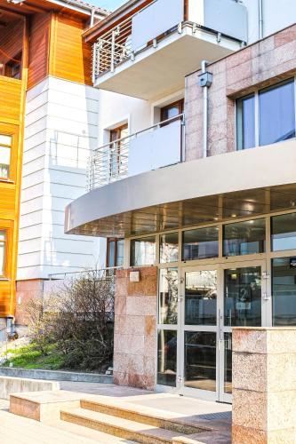 an external view of a building with glass doors at Apartament Relax Neptun Park in Gdańsk