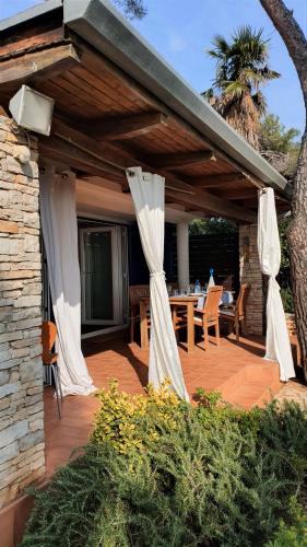 a wooden deck with a table and chairs on it at Mediterranean Beach House in Umag