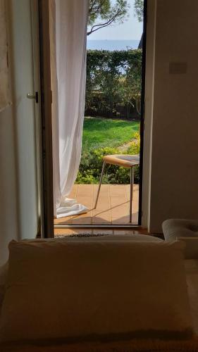 a door open to a patio with a chair outside at Mediterranean Beach House in Umag