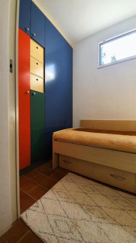a bedroom with a bed and a colorful wall at Mediterranean Beach House in Umag