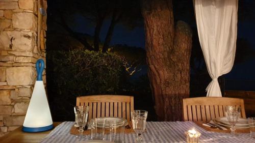 a table with plates and glasses on top of it at Mediterranean Beach House in Umag