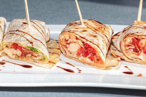 a white plate with four wrap sandwiches on it at Reinosa Atalaya-La Vega in Reinosa