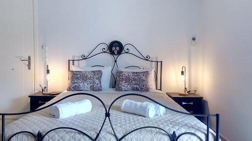 a bedroom with a large bed with two pillows at Spyros Studio in Nafplio