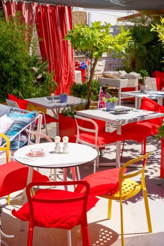 a group of tables with red and white chairs at Domus Maritima in Trogir