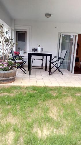 a patio with a table and chairs on a porch at Spyros Studio in Nafplio