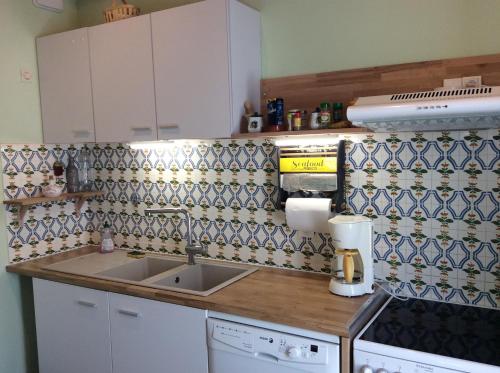 une cuisine avec un évier et un plan de travail dans l'établissement Maison Ile de Re, à La Couarde-sur-Mer