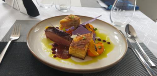 een wit bord met eten op een tafel bij TeoDorka Med & SPA in Ciechocinek