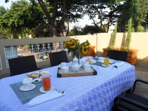 a blue table with food and drinks on it at North Star Hostal Guayaquil in Guayaquil