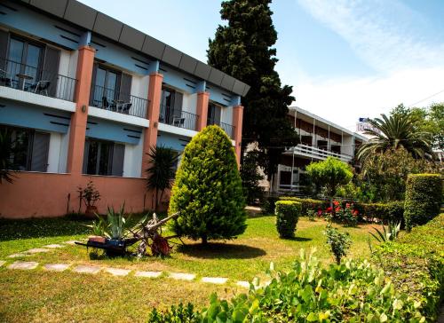 a person sitting on a bench in front of a building at Violetta in Kamena Vourla