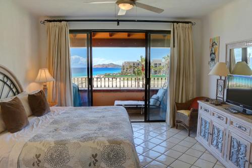 a bedroom with a bed and a view of the ocean at Condominios El Dorado II in Cabo San Lucas
