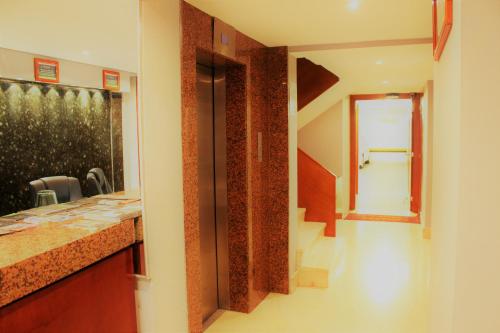 a hallway of a house with a staircase and a mirror at Condesa Suites in Mexico City
