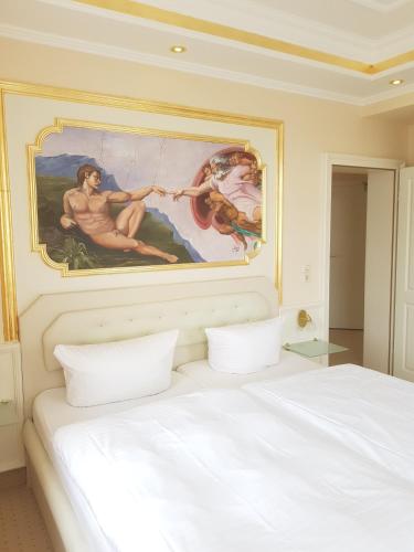 a bedroom with a painting above a bed at Pension Giesserstrasse Leipzig in Leipzig