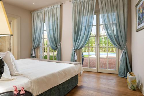 a bedroom with a bed and a large window at Villa Zara in Vabriga