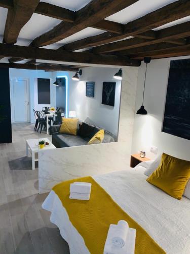a bedroom with a large bed and a living room at VUT- La Deliciosa in Sotillo de la Adrada