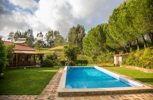 a swimming pool in a yard with a house at Quinta Camarena in Cercal