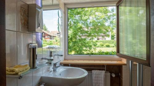 a bathroom with a sink and a large window at Gästehaus Guter Stern in Bad Steben