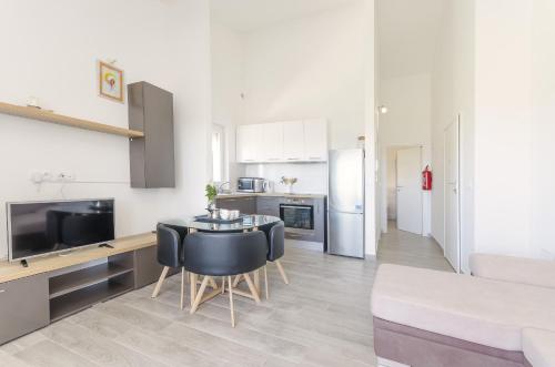 a kitchen and living room with a table and chairs at Apartments Endless summer in Srima