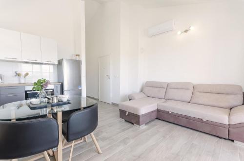 a living room with a couch and a table at Apartments Endless summer in Srima