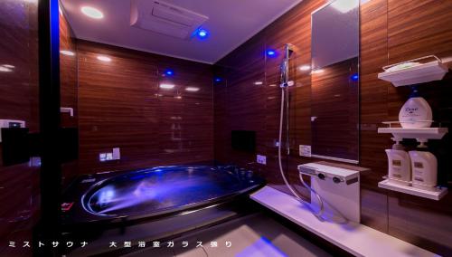a bathroom with a blue tub in a room at aloalo in Fujikawaguchiko