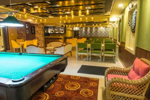 a pool table in a room with a restaurant at Mount Breeze Hotel in Mount Lavinia