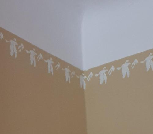 a group of people hanging on a line on a wall at Rīgas 20/1 apartaments in Cēsis