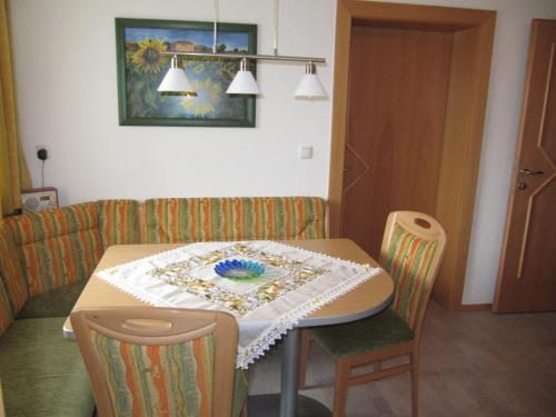 a dining room table with a table cloth on it at Gästehaus Luxner in Strass im Zillertal