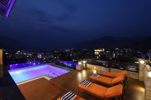 a swimming pool on top of a building at night at Hotel Mala Pokhara in Pokhara