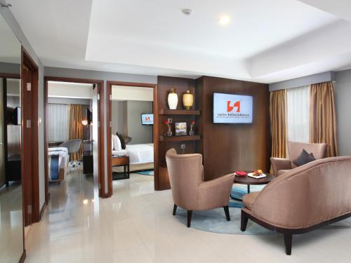 a hotel room with a bedroom and a living room at Swiss-Belresidences Rasuna Epicentrum in Jakarta