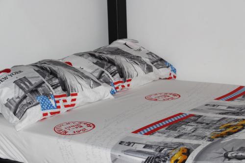 
a bed that has a bunch of pillows on it at Apartamentos Excelente Ubicación in Medellín
