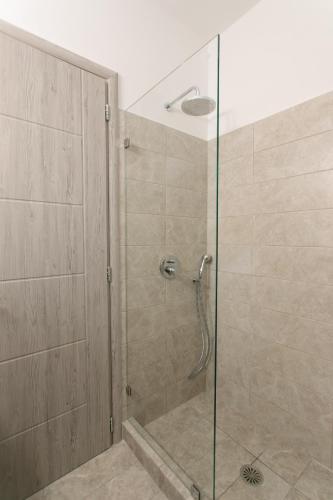a shower with a glass door in a bathroom at Sweet Home Naxos in Naxos Chora