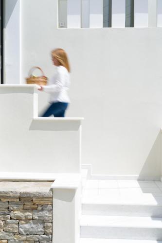 a woman walking up the stairs of a house at Sweet Home Naxos in Naxos Chora