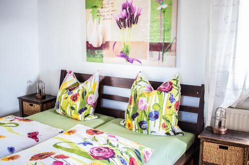 two beds with colorful pillows sitting next to each other at Gästehaus zum Felsen in Überlingen