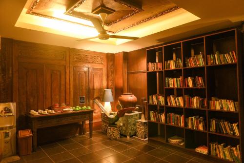 a room with a library with a desk and book shelves at Peneeda View Beach Hotel in Sanur