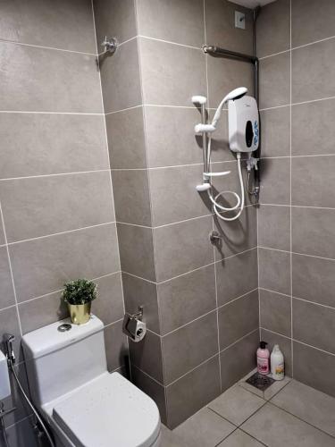 a bathroom with a shower and a toilet in it at Dsara Netflix tv 5 pax direct mrt next segi college in Sungai Buluh