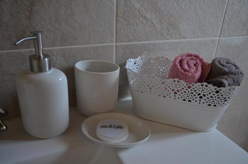 a bathroom counter with a soap dispenser and some towels at La Villa "Casa di Lydia" in Gavalochori