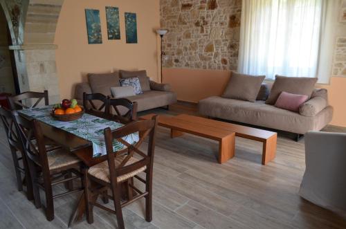 a living room with a table and a couch at La Villa "Casa di Lydia" in Gavalochori