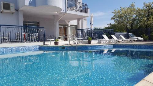 a swimming pool with blue water in front of a building at Hotel Yo in St. St. Constantine and Helena