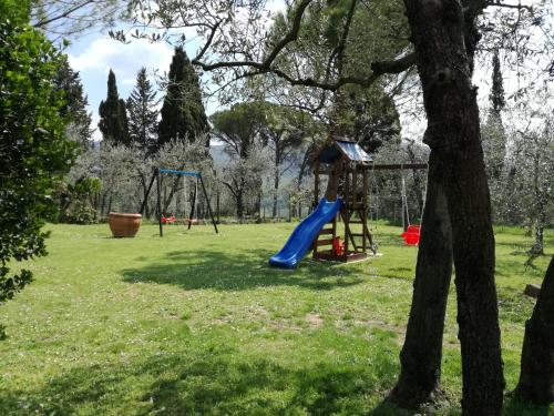 a playground in a park with a blue slide at Agriturismo IL VIAIO in Fiesole